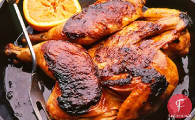 Frango laranja ao estilo asiático assado sob um tijolo