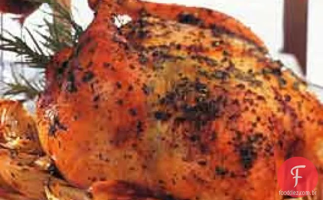 Frango assado com manteiga de ervas, cebola e alho