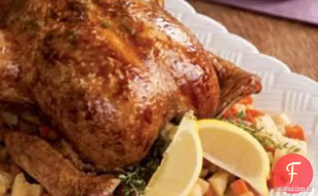 Frango inteiro assado com erva-limão em uma cama de vegetais