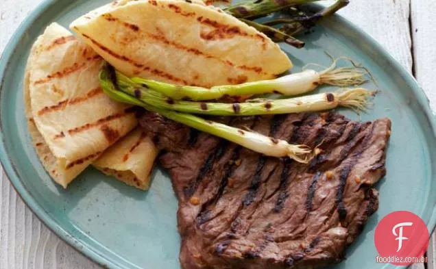 Bife de saia marinada em estilo coreano com cebolinha grelhada e tortilhas quentes